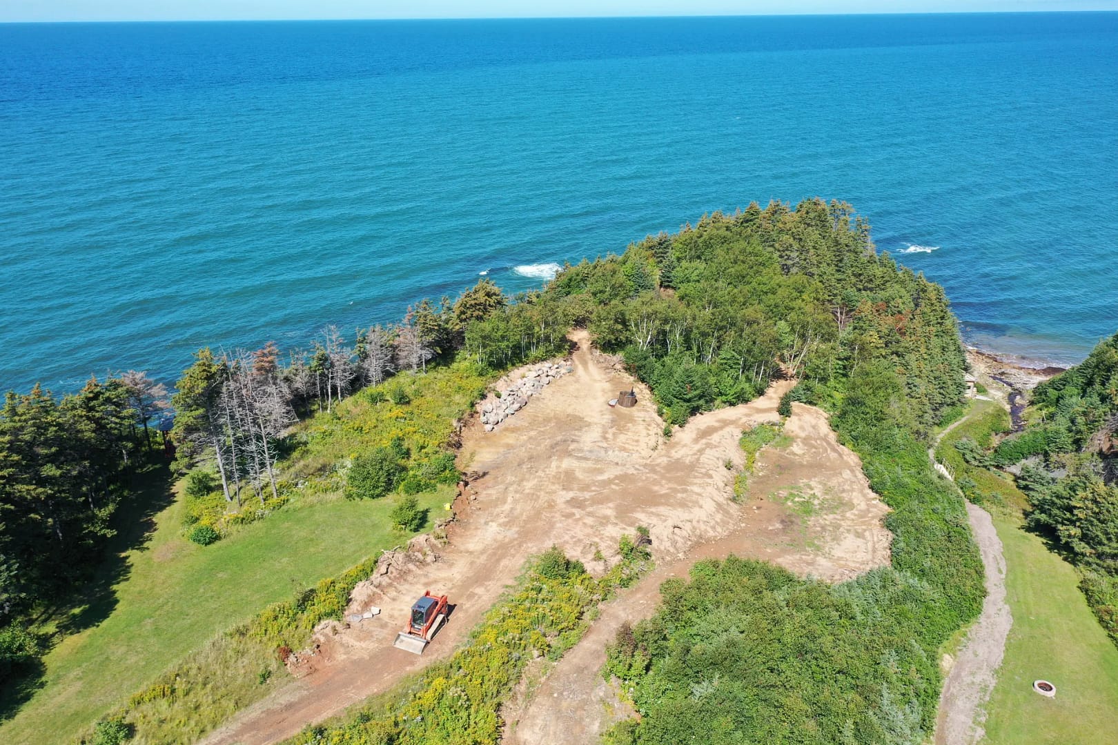 Aerial View Of Bulldozer Working On Ocean Peninsula