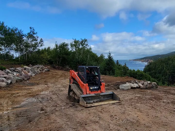 Bulldozer On Smoothed Land With Ocean Behind